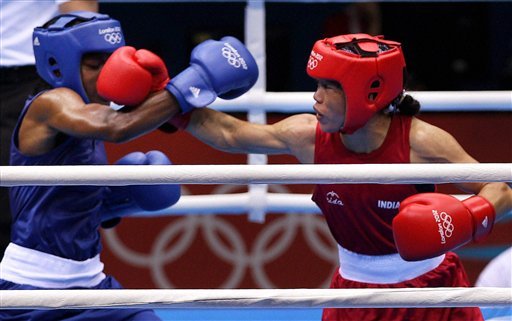 Great Britain's Nicola Adams, right, and India's Chungneijang Mery Kom Hmangte fight during their women's flyweight 51-kg semifinal boxing match
