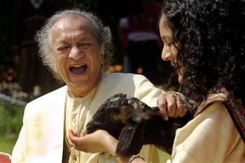 Ravi Shankar, left, and his daughter Anoushka Shankar laugh during the shooting of a film endorsing the strengthening of Indian laws against animal cruelty
