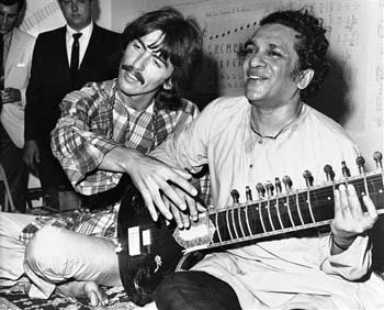 George Harrison, of the Beatles, left, sits cross-legged with his musical mentor, Ravi Shankar 
