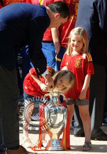 Spain's  Crown Prince Felipe, left points as Spain's Princess Leonor, centre puts her arm into the Euro 2012 trophy next to Princess Sofia right during a visit by the national soccer team members to the Zarzuela Palace in Madrid

