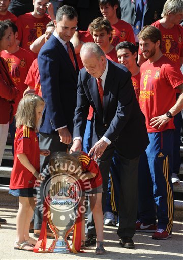 Spain's  Crown Prince Felipe, left points as Spain's Princess Leonor, centre puts her arm into the Euro 2012 trophy next to Princess Sofia right during a visit by the national soccer team members to the Zarzuela Palace in Madrid
