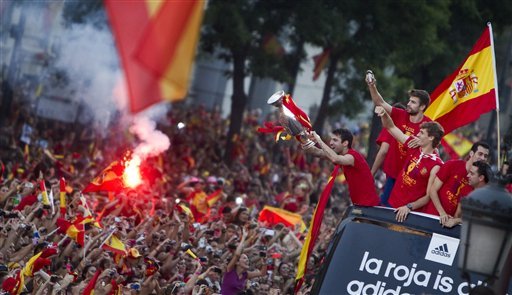 Spain's soccer team players show the Euro cup as they wave to supporters at Cibeles Square in Madrid, Spain
