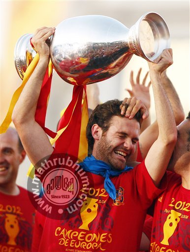Juan Matta holds the trophy with teammates during the celebration of the Euro 2012 soccer championship in Madrid, Spain
