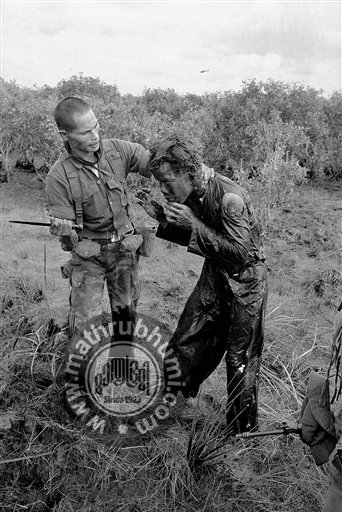  In this Jan. 9, 1964 file photo one of several shot by Associated Press photographer Horst Faas, earning him the first of two Pulitzer Prizes, a South Vietnamese soldier uses the end of a dagger to beat a farmer for allegedly supplying government tr
