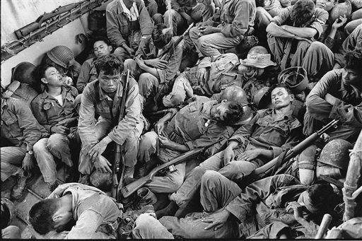 In this Aug. 1962 file photo shot by Associated Press photographer Horst Faas, South Vietnamese government troops from the 2nd Battalion of the 36th Infantry sleep in a U.S. Navy troop carrier on their way back to the Provincial capital of Ca Mau, Vi
