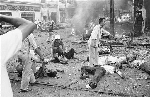  In this March 30, 1965 file photo taken by Associated Press photographer Horst Faas, injured Vietnamese receive aid as they lie on the street after a bomb explosion outside the U.S. Embassy in Saigon, Vietnam. Faas, a prize-winning combat photograph

