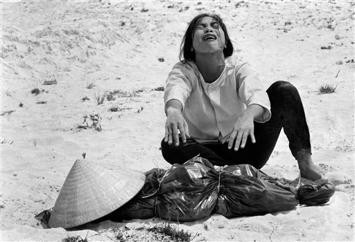 In this April 1969 file photo shot by Associated Press photographer Horst Faas, a South Vietnamese woman mourns over the body of her husband, found with 47 others in a mass grave near Hue, Vietnam. Faas, a prize-winning combat photographer who carved
