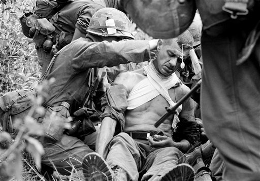 In this Jan. 16, 1966 file photo taken by Associated Press photographer Horst Faas, Lt. Col. George Eyster of Florida is placed on a stretcher after being shot by a Viet Cong sniper at Trung Lap, South Vietnam.
