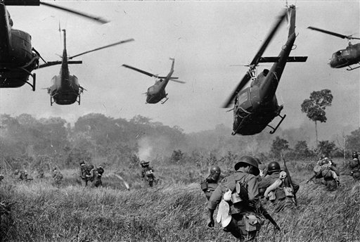 In this March 1965 file photo shot by Associated Press photographer Horst Faas, hovering U.S. Army helicopters pour machine gun fire into the tree line to cover the advance of South Vietnamese ground troops in an attack on a Viet Cong camp 18 miles n
