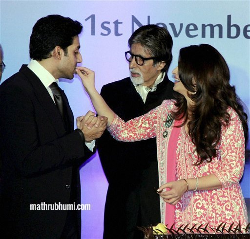 Bollywood actress Aishwarya Rai Bachchan offers cake to her husband actor Abhishek Bachchan as her mega actor Amitabh Bachchan looks on during her birthday celebration in Mumbai on Thursday. Aishwarya was conferred with the French civilian award, Officer Dan Ordre Arts et des Lettres at the function. PTI Photo 
