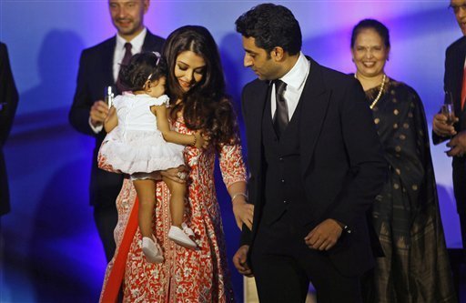 Bollywood actress Aishwarya Rai Bachchan holds her daughter Aaradhya as her husband actor Abhishek Bachan walks with her during a function where she received the second highest French civilian award 'Officer Dan Ordre Arts et des Lettres', in Mumbai, India Thursday, Nov 1, 2012 

