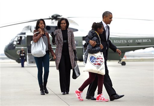 Barack Obama, accompanied by first last Michelle Obama and daughters Malia and Sasha, arrive at the election night party 
