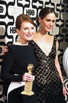 Actress Julianne Moore, winner of the award for best actress in a miniseries for 'Game Change,' left, and Sarah Paulson arrive at the HBO Golden Globe
