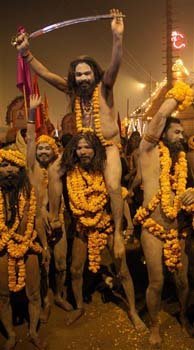 Naked Hindu holy men or a Naga Sadhus shout slogans after taking a dip at Sangam
