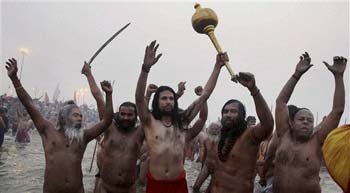 Hindu holy men, or Naga Sadhus, celebrate naked in the water at Sangam
