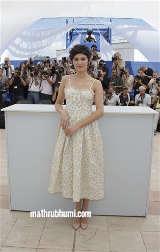 Actress Audrey Tautou, who will host the Cannes Film Festival opening ceremony on Wednesday, poses for photographers at the 66th international film festival, in Cannes, southern France, Tuesday, May 14, 2013. (AP  
